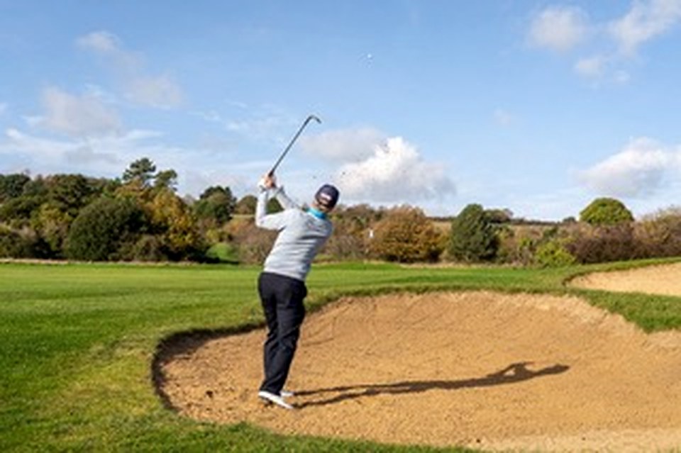 Bunker shot exploding sand