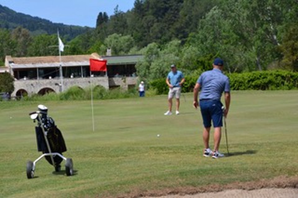 Putting green with stone clubhouse
